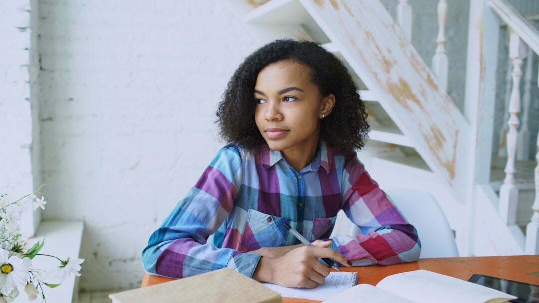 Journalist woman writing notes at her desk
