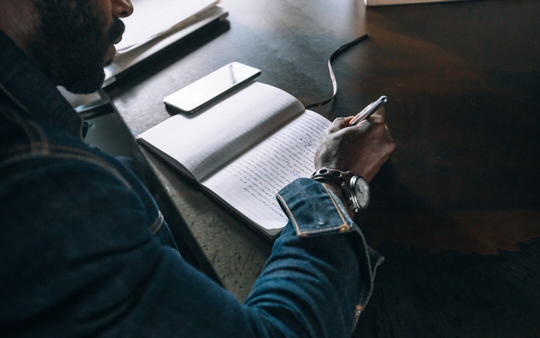 man writing book